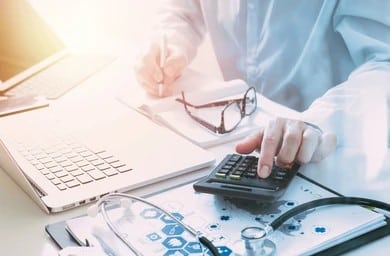 Dermatologist calculating patient bills during soft collections process
