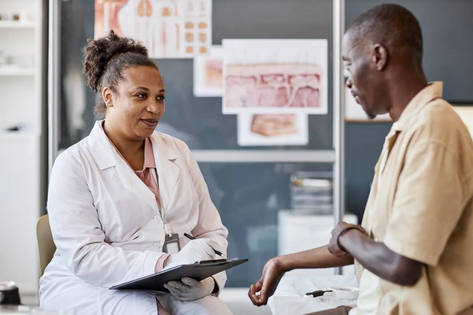 Dermatologist discussing a patient's skin condition during a consultation